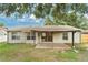 Rear view of the house showcasing the covered patio, siding, and partially fenced backyard at 837 Greenbelt Cir, Brandon, FL 33510