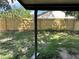 A backyard with grass and a wood privacy fence at 837 Greenbelt Cir, Brandon, FL 33510