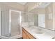 Bathroom with double sinks, vanity, large mirror, and glass door shower enclosure at 837 Greenbelt Cir, Brandon, FL 33510