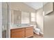 Primary bathroom featuring double sinks, wood cabinets, a large mirror, and a separate shower at 837 Greenbelt Cir, Brandon, FL 33510