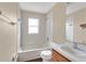Clean bathroom with white tiled tub and shower combination, plus a vanity with wood cabinets at 837 Greenbelt Cir, Brandon, FL 33510