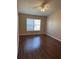 Comfortable bedroom with wood floors, fan and a sunlit window at 837 Greenbelt Cir, Brandon, FL 33510