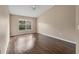 Neutral bedroom with wood-look flooring and a large window overlooking the backyard at 837 Greenbelt Cir, Brandon, FL 33510