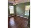 Inviting bedroom with warm green walls and wood flooring at 837 Greenbelt Cir, Brandon, FL 33510