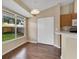 Dining area with wood-look flooring, a view of the backyard, and access to the adjacent kitchen at 837 Greenbelt Cir, Brandon, FL 33510