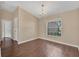 Empty dining room featuring wood floors, a chandelier, and a large window at 837 Greenbelt Cir, Brandon, FL 33510