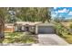 Charming single-story home with a well-manicured lawn and mature trees at 837 Greenbelt Cir, Brandon, FL 33510