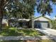 Charming single-story home featuring a well-maintained front yard and attached two-car garage at 837 Greenbelt Cir, Brandon, FL 33510