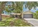 Charming single-story home featuring a manicured lawn and an attached two-car garage at 837 Greenbelt Cir, Brandon, FL 33510