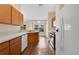 Well-lit kitchen with wood cabinets and modern appliances, open to the dining area with a view of the backyard at 837 Greenbelt Cir, Brandon, FL 33510