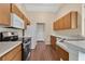 Efficient kitchen with wooden cabinets, stainless steel appliances, and ample counter space at 837 Greenbelt Cir, Brandon, FL 33510