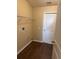 Convenient laundry room with shelving and a bright white door at 837 Greenbelt Cir, Brandon, FL 33510