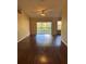 Bright living room featuring sleek wood floors, ceiling fan and sliding glass doors to the backyard at 837 Greenbelt Cir, Brandon, FL 33510
