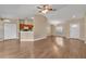 Open-concept living room with wood-look flooring and an abundance of natural light from the front door and kitchen at 837 Greenbelt Cir, Brandon, FL 33510