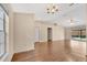 Bright living room featuring wood-look flooring, a chandelier, and sliding glass doors to the backyard at 837 Greenbelt Cir, Brandon, FL 33510
