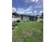 Lush backyard with a screen enclosed lanai and privacy fence at 4924 Creekside Trl, Sarasota, FL 34243