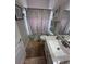 Bathroom showcasing a vanity with granite countertop and decorative nautical themed shower curtain at 4924 Creekside Trl, Sarasota, FL 34243