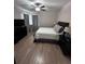 Inviting bedroom featuring hardwood floors, a ceiling fan, and neutral decor at 4924 Creekside Trl, Sarasota, FL 34243