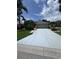 Charming single-story home featuring lush tropical landscaping and a wide driveway leading to a two-car garage at 4924 Creekside Trl, Sarasota, FL 34243