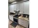 Close up shot of the kitchen with stainless steel appliances, granite countertops, and white cabinets at 4924 Creekside Trl, Sarasota, FL 34243