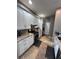 Modern kitchen featuring stainless steel appliances, granite countertops, and white cabinets at 4924 Creekside Trl, Sarasota, FL 34243