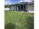 Beautiful screen enclosed lanai with paved patio and well-maintained lawn at 4924 Creekside Trl, Sarasota, FL 34243