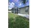 The screened in lanai features tiled flooring and ample natural light at 4924 Creekside Trl, Sarasota, FL 34243