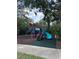 Colorful community playground with slides, climbing structures, and soft ground covering at 4924 Creekside Trl, Sarasota, FL 34243