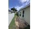 Side yard with a rock garden bed and healthy green grass at 4924 Creekside Trl, Sarasota, FL 34243