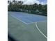 Well-maintained tennis court on a sunny day, ready for a match at 4924 Creekside Trl, Sarasota, FL 34243