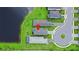 Aerial view of a home and community with lush greenery and lake access at 6256 Baywood Ct, Bradenton, FL 34211
