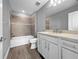 Well-lit bathroom with a soaking tub, tiled shower, and modern vanity at 6256 Baywood Ct, Bradenton, FL 34211