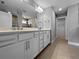 Spacious bathroom with double vanity, sleek cabinets, and modern fixtures and a tiled shower at 6256 Baywood Ct, Bradenton, FL 34211