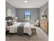 Inviting bedroom with a plush bed, area rug, and a soothing color scheme at 6256 Baywood Ct, Bradenton, FL 34211