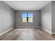 Bright bedroom featuring wood floors and a window view overlooking the water at 6256 Baywood Ct, Bradenton, FL 34211