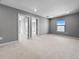 Expansive bonus room showcasing neutral carpeting and natural light from the window at 6256 Baywood Ct, Bradenton, FL 34211