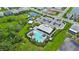 Aerial view of the community pool, playground, and parking area with green surroundings at 6256 Baywood Ct, Bradenton, FL 34211
