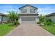 Well-maintained two-story home with a paved driveway and neatly landscaped front yard at 6256 Baywood Ct, Bradenton, FL 34211