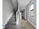 Hallway with wood-look tile floors leading to carpeted stairs at 6256 Baywood Ct, Bradenton, FL 34211
