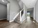 Hallway with wood-look tile floors leading to carpeted stairs at 6256 Baywood Ct, Bradenton, FL 34211