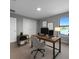 Well-lit home office with modern desk, computer, and serene water view at 6256 Baywood Ct, Bradenton, FL 34211