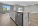 An island in a modern kitchen with an integrated stainless steel dishwasher at 6256 Baywood Ct, Bradenton, FL 34211