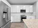 A close up of a kitchen with stainless steel appliances, range and white cabinets at 6256 Baywood Ct, Bradenton, FL 34211