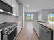 A modern kitchen with white cabinets, a kitchen island, and a view to the water at 6256 Baywood Ct, Bradenton, FL 34211