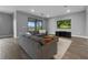 Comfortable living room featuring wood flooring, a modern TV, and stylish grey furniture at 6256 Baywood Ct, Bradenton, FL 34211