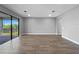 Bright and open living space with wood floors and large sliding glass doors to patio at 6256 Baywood Ct, Bradenton, FL 34211