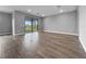 Spacious room featuring wood floors and a sliding glass door leading to an outdoor patio at 6256 Baywood Ct, Bradenton, FL 34211