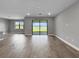 Bright living space with wood floors and a large sliding glass door to the lanai overlooking the water at 6256 Baywood Ct, Bradenton, FL 34211