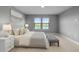 A bedroom with matching nightstands, a tufted headboard and bench at 6256 Baywood Ct, Bradenton, FL 34211
