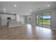 Open floorplan with wood floors, a modern kitchen, and a view of the backyard at 6256 Baywood Ct, Bradenton, FL 34211